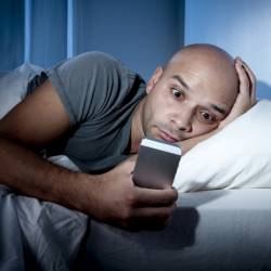 man addicted smartphone bed